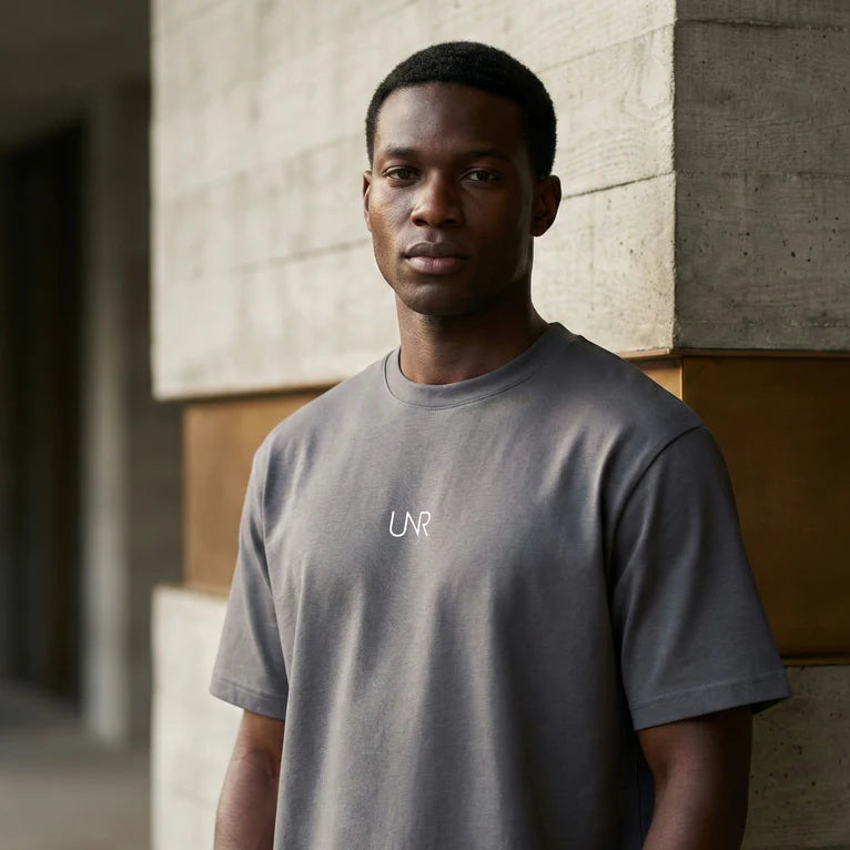 Black UNR Climate Tee with chest logo worn outdoors